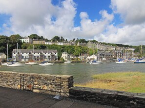 A harbor with boats, stone walls, and buildings in the background. - 56C South Snowdon Wharf (Porthmadog)