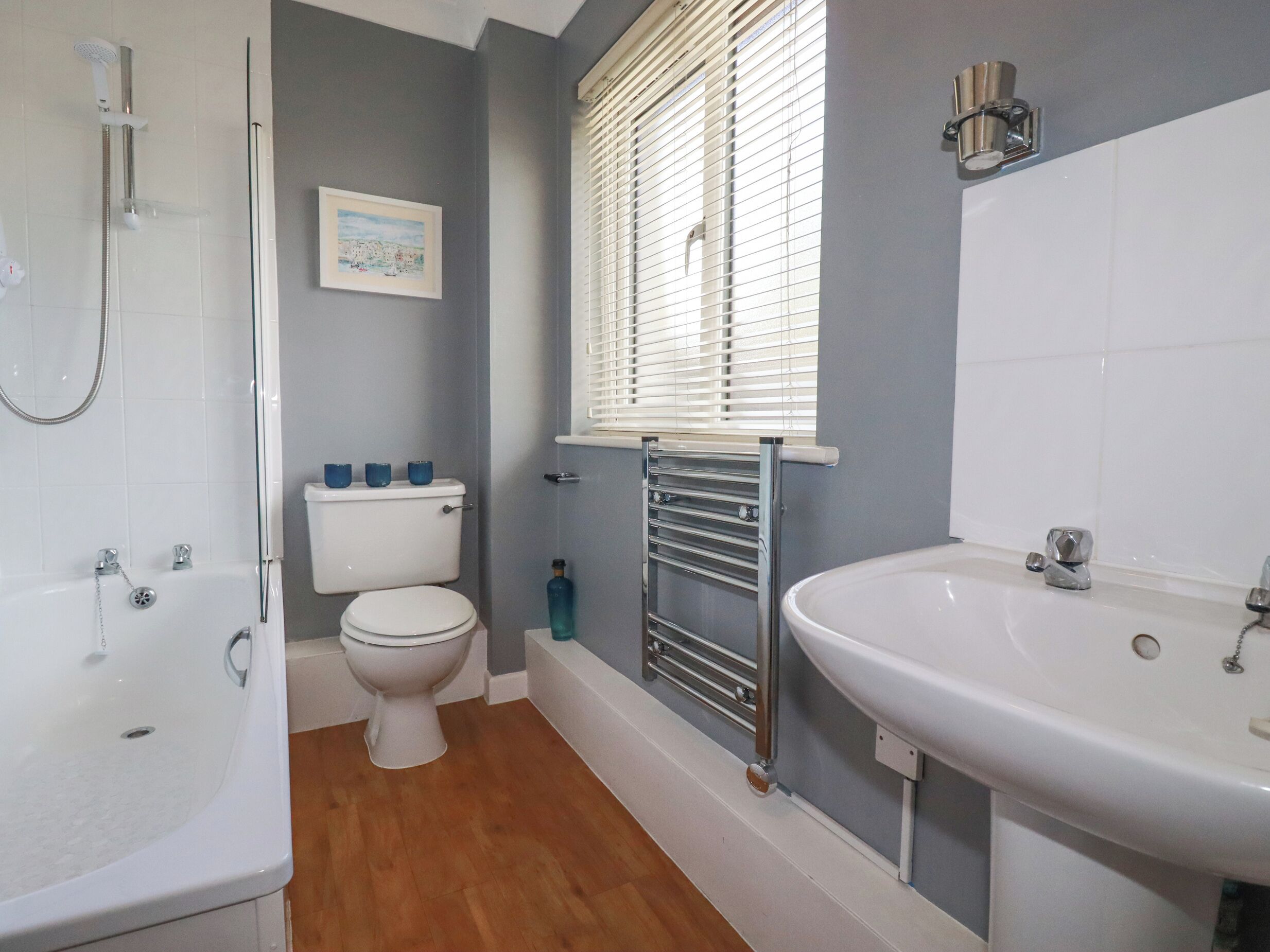 A bathroom with a bathtub, toilet, and sink.