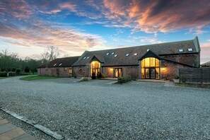 A large building with multiple brick structures and a gravel driveway. - Widgeon (Beccles)