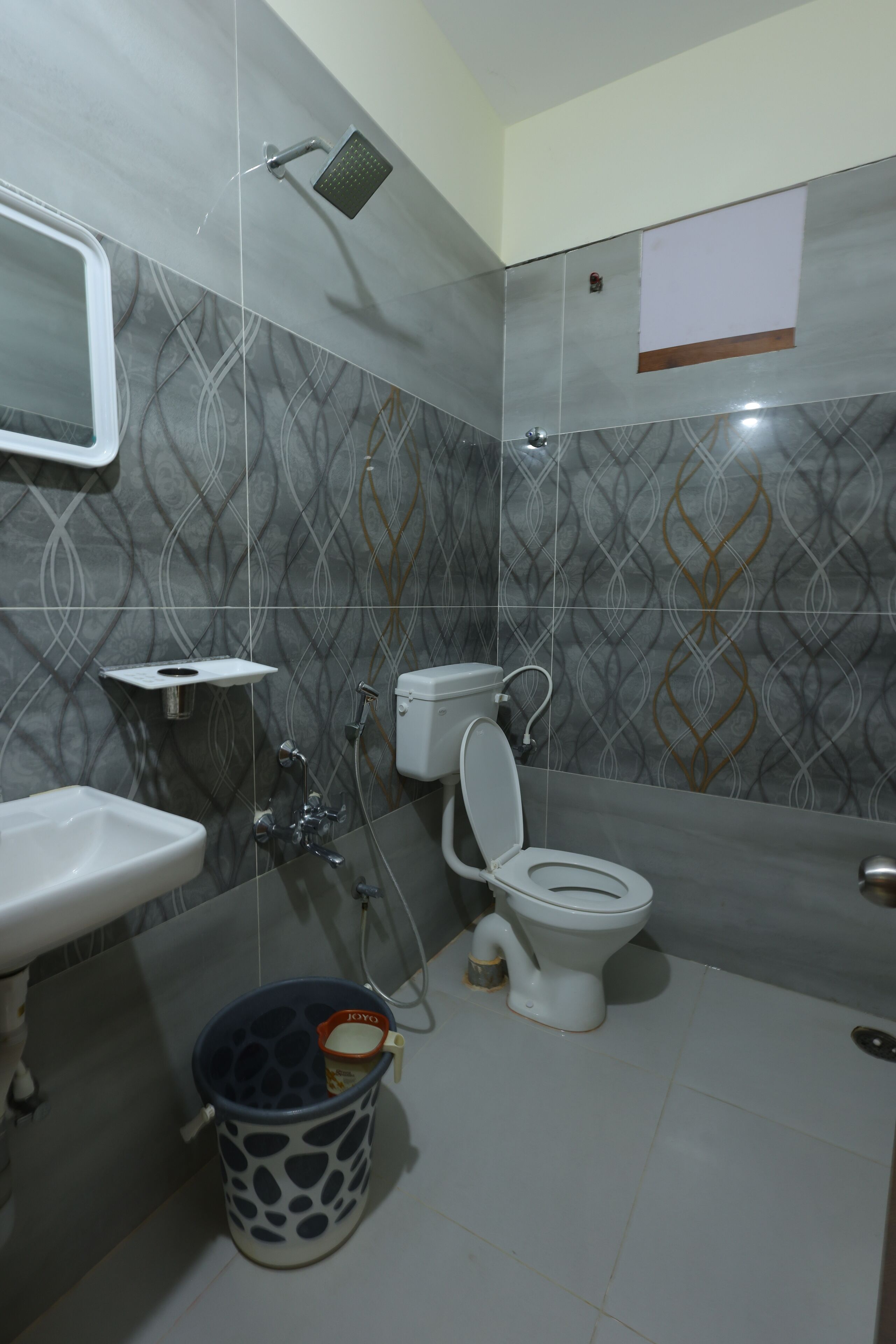 A bathroom with a toilet, sink, and shower.