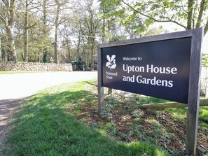 A welcome sign for Upton House and Gardens, indicating it is a National Trust property. - Oldwyche Barns (Warwick)