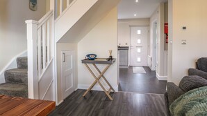 Een modern interieur met een trap, een keukenhoek en een zithoek.