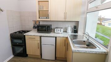 Fridge, electric kettle, toaster, cookware/dishes/utensils