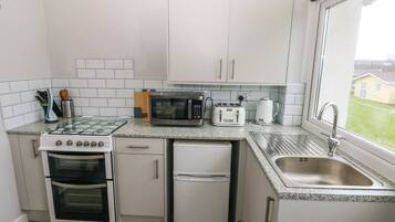 Fridge, electric kettle, toaster, cookware/dishes/utensils