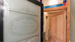 A hallway with a wooden door labeled "The Old Post Office." - The Old Post Office (York)