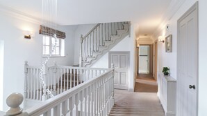 A staircase with white railings and a light fixture above it. - Hardy's Way 34 (Canvey Island)