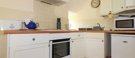 Fridge, electric kettle, toaster, cookware/dishes/utensils
