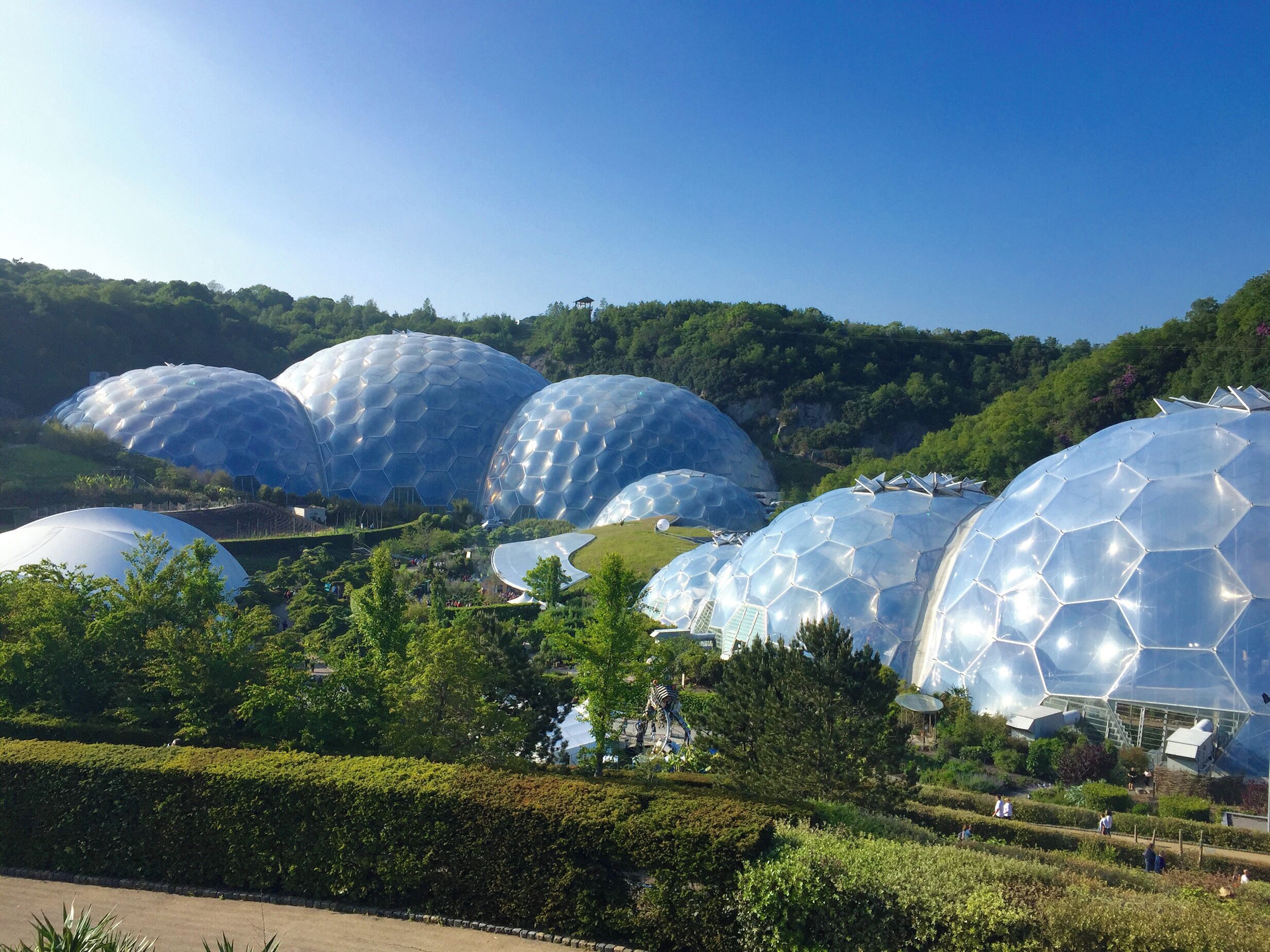 A series of large, dome-shaped structures with a reflective surface, surrounded by well-maintained greenery and pathways.