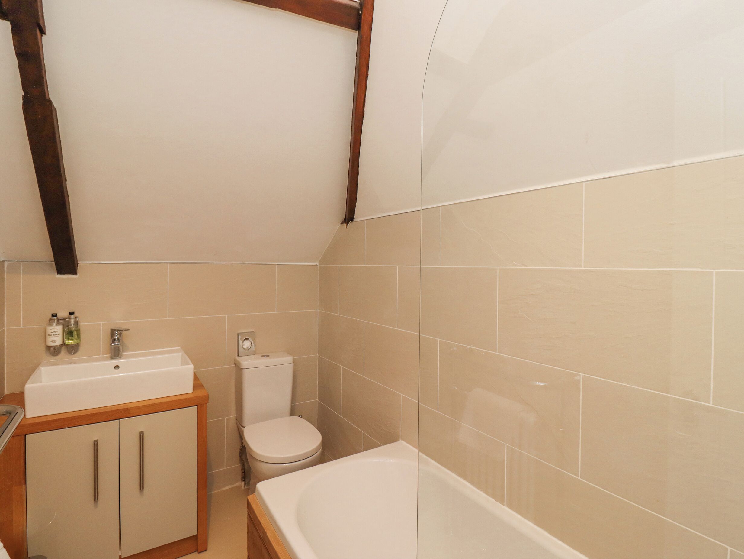 A bathroom with a bathtub, toilet, and sink.