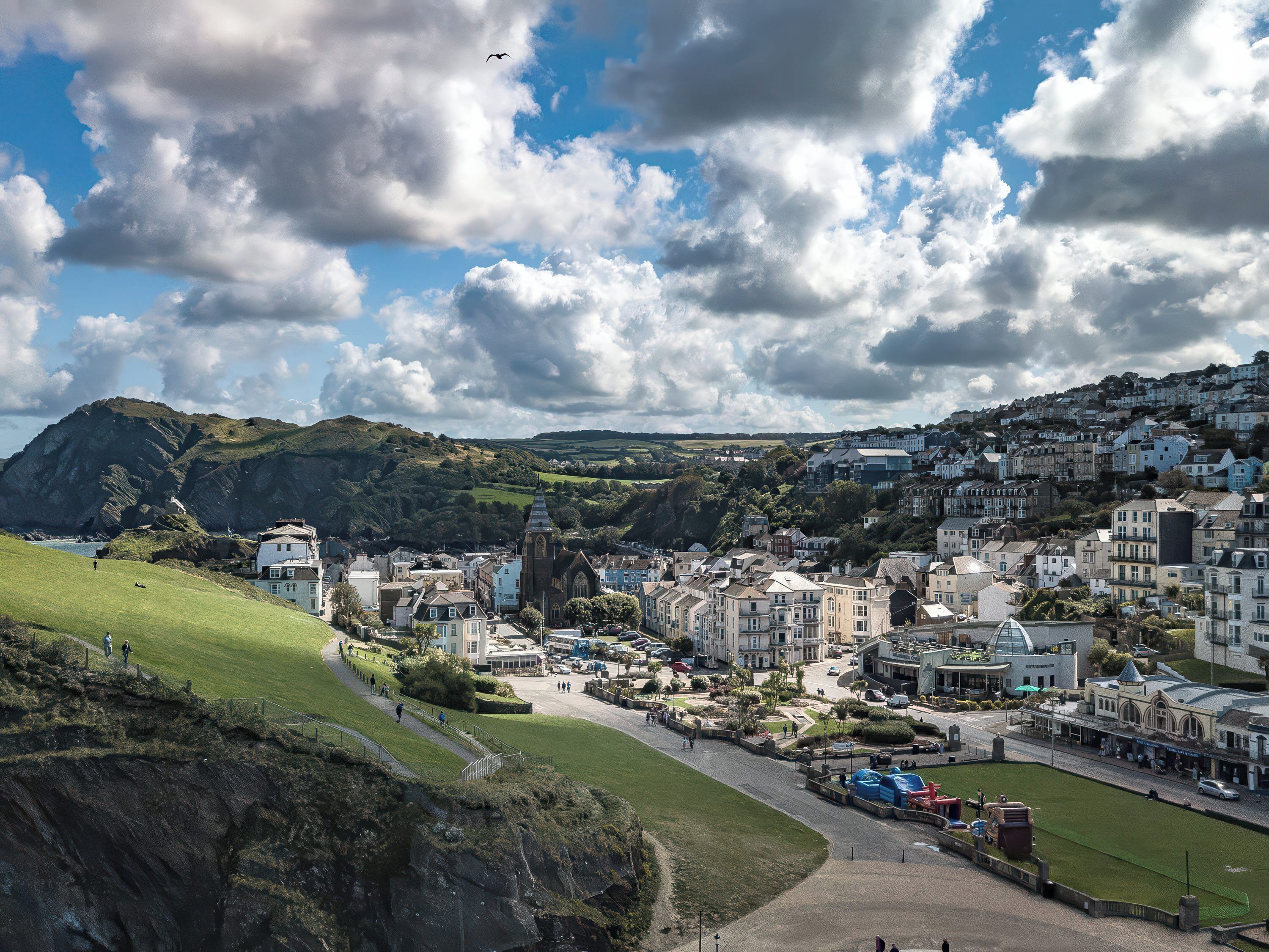 A coastal town with a prominent church, a main street, and residential buildings.