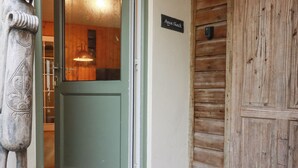 A wooden door with a sign reading "Agua Shack" and a pet bowl outside. - The Aqua Shack (Newquay)