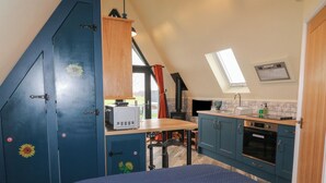 A compact kitchen with a built-in oven, a sink, and a stove. - Sunflower Lodge (Doncaster)