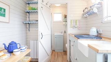 Fridge, electric kettle, cookware/dishes/utensils