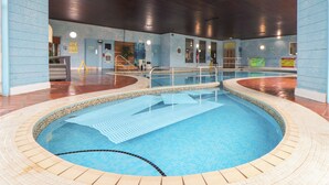 An indoor swimming pool with a tiled floor and a wooden ceiling. - Skylarks! (St. Agnes)