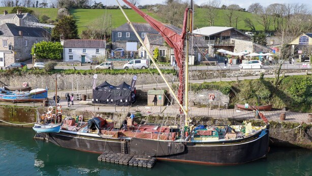 A large boat docked at a pier with a town in the background. - 20 Keay Heights (St Austell)