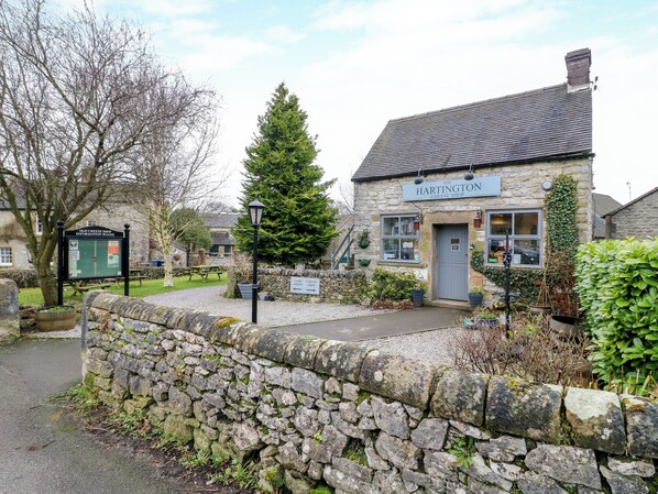 A stone building with a sign reading "The Hartington Cheese Shop."