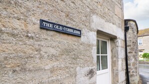 A stone building with a sign reading "THE OLD COBBLES". - The Old Cobblers (Skipton)