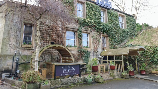 A building with a sign reading "The Valley" and a wooden archway entrance. - Kerangarth (Corbridge)