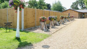 A wooden fence with a sign indicating a glamping area with no dogs allowed. - Rabbit Warren Lodge (King's Lynn)