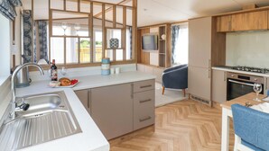 A compact kitchen with a sink, stove, and dining area.