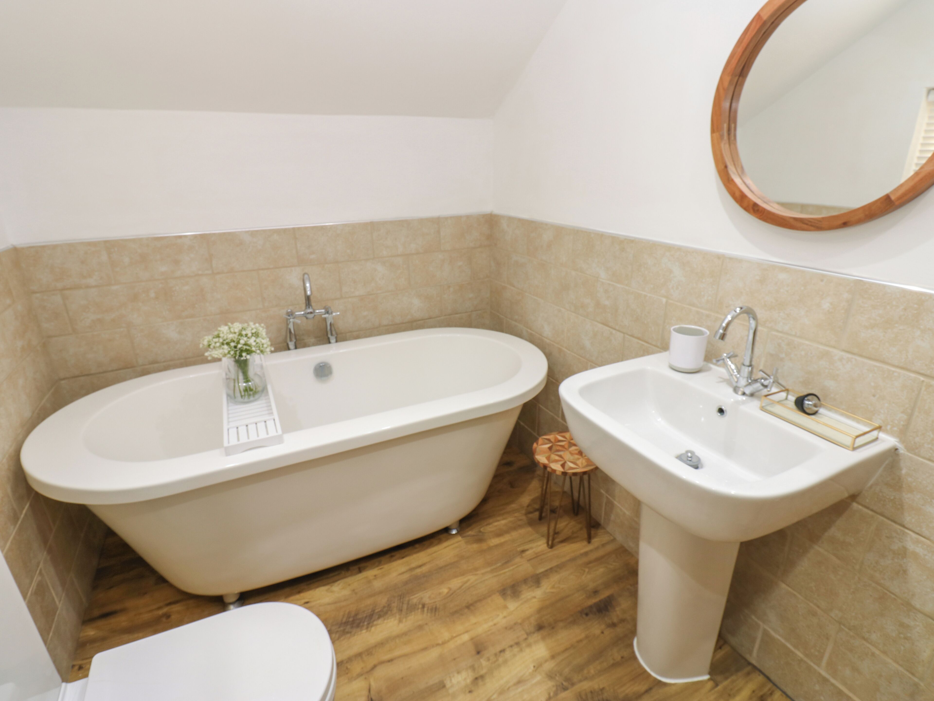 A bathroom with a freestanding bathtub, a sink, and a toilet.