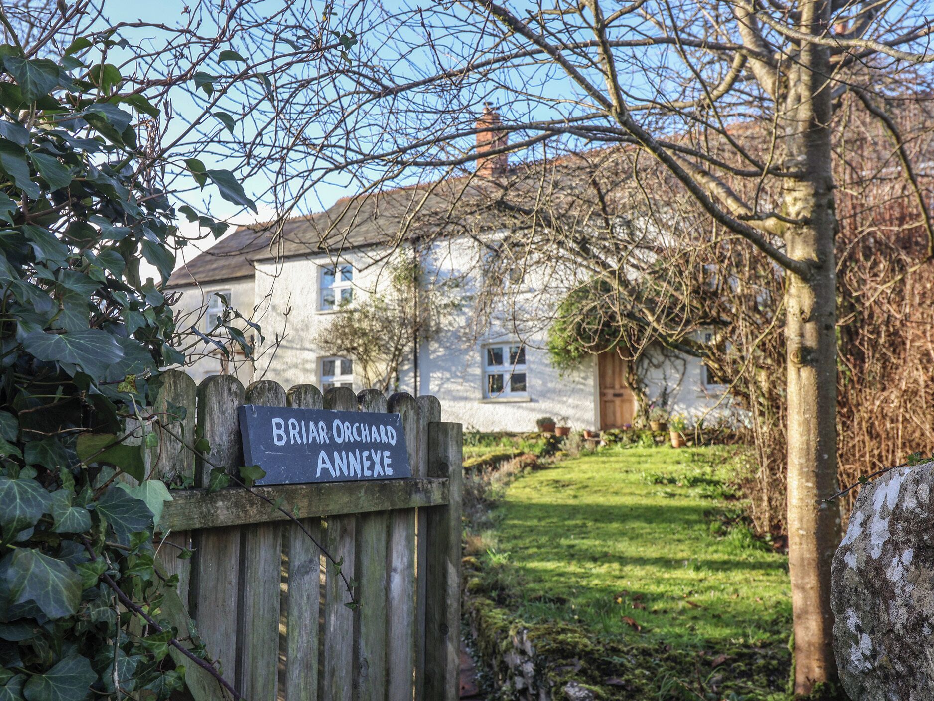 A wooden gate with a sign reading "Briar Orchard Annexe".