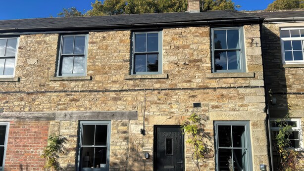 A two-story stone building with multiple windows and a door. - Cedar Cottage (Barnard Castle)