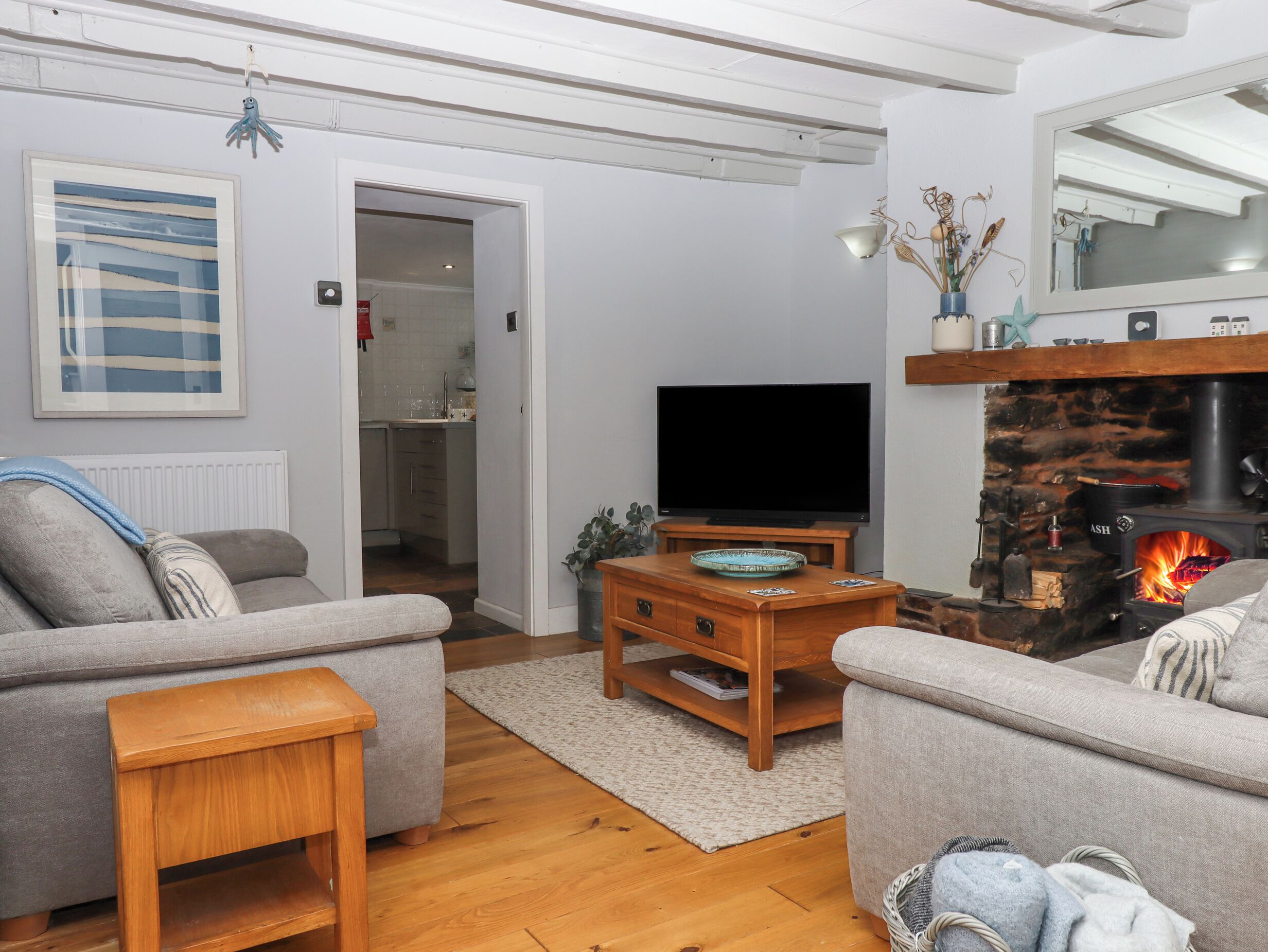 A living room with a fireplace, a television, and a sofa.
