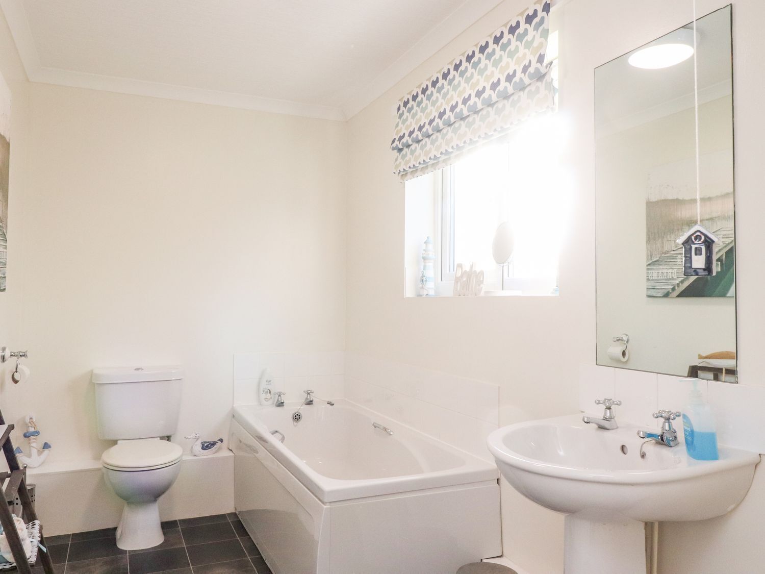 A bathroom with a toilet, bathtub, and sink.