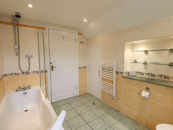 A bathroom with a bathtub, a shower, a toilet, and a sink.