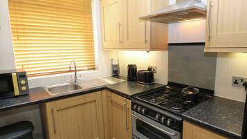 Fridge, electric kettle, toaster, cookware/dishes/utensils