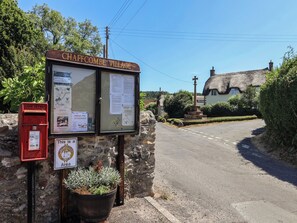 A village sign for Chaffcombe Village with a post office and a neighborhood watch sign. - Woodstock (Chard)