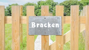 Une clôture en bois sur laquelle est affiché un panneau indiquant « Bracken ».