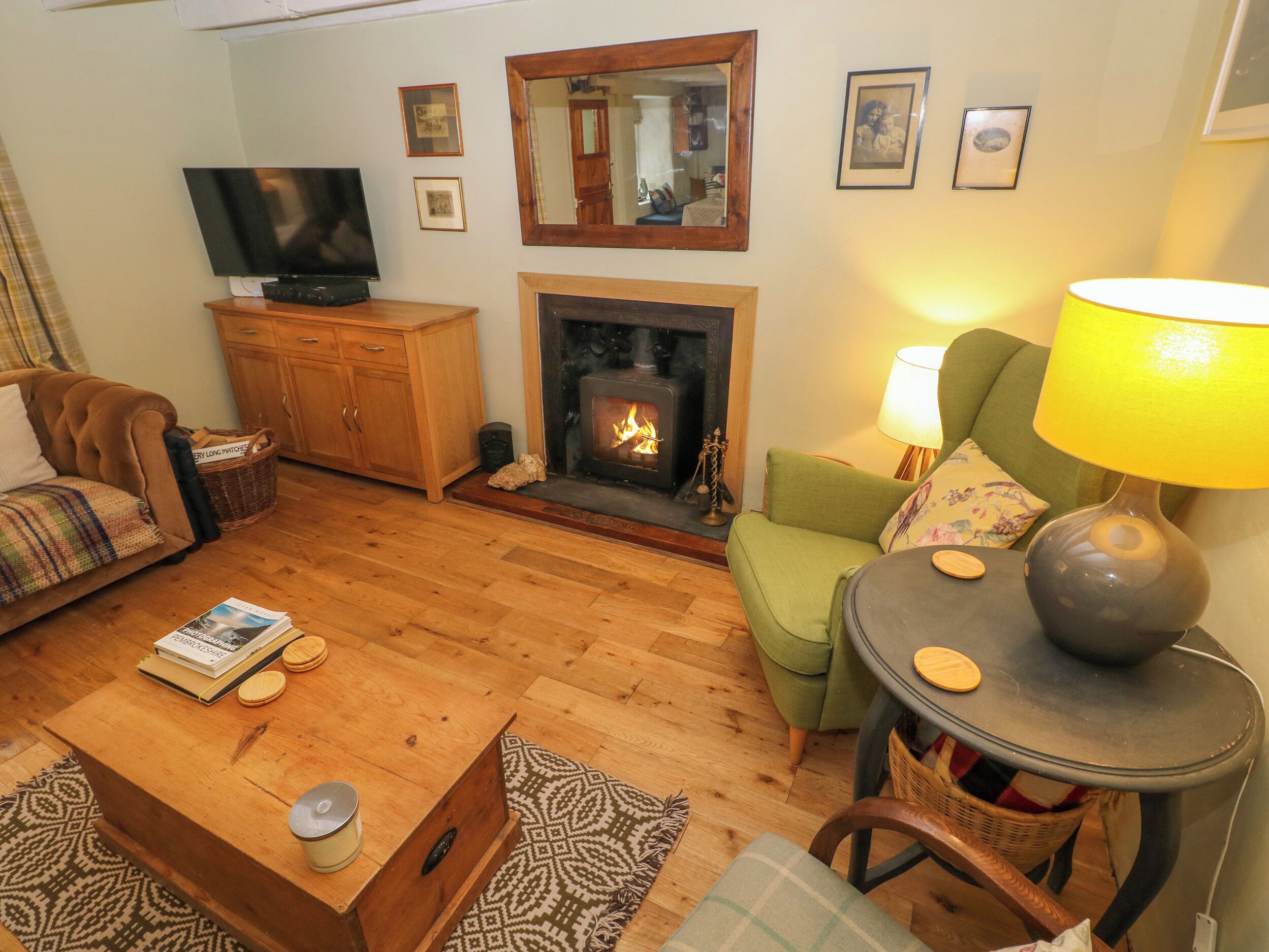 A cozy living room with a fireplace, a television, and comfortable seating.