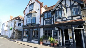 A traditional building with a sign for 'The Puggle Coaching Inn' indicating it is a coaching inn. - Seapie Corner (Yarmouth)