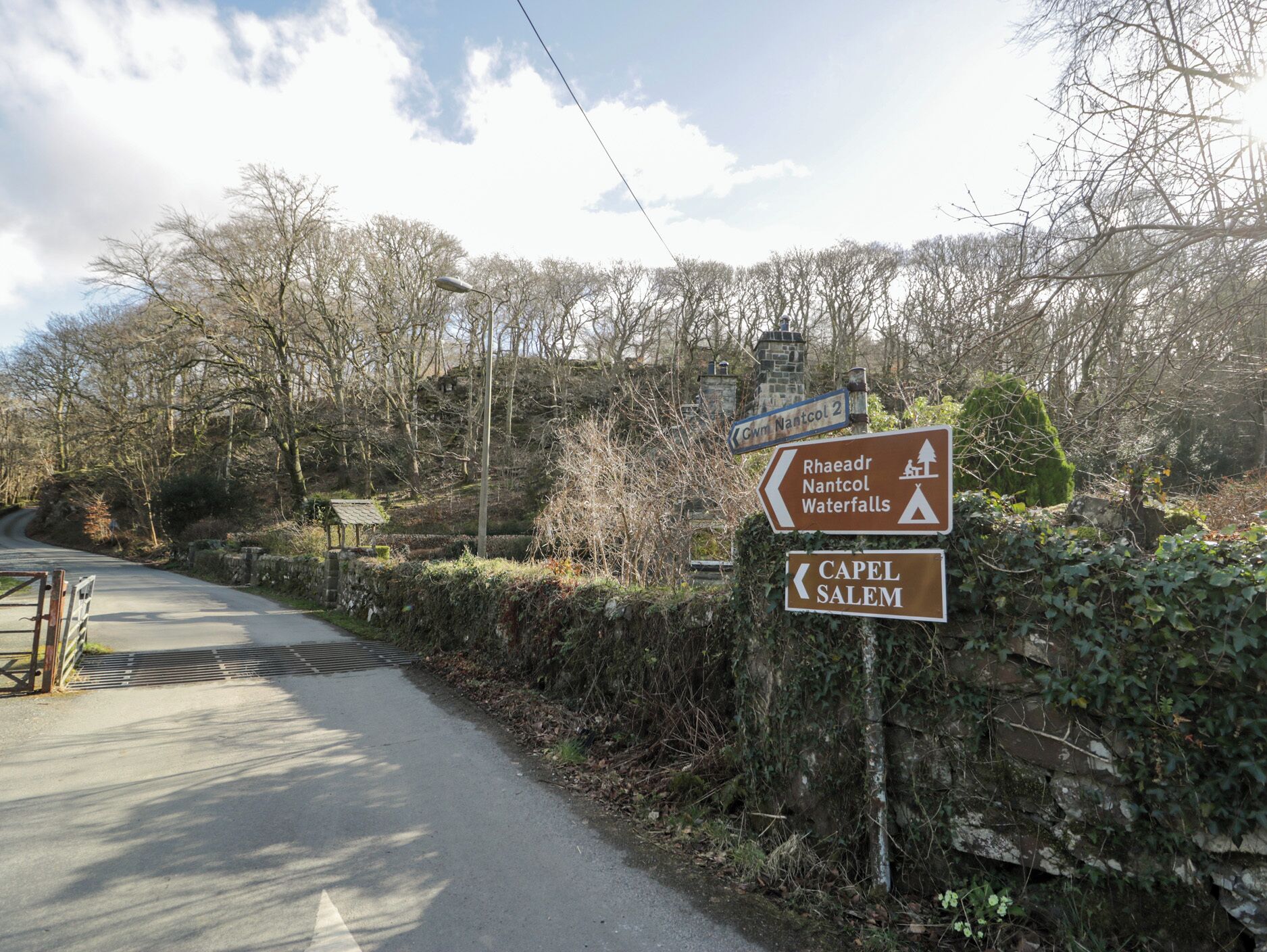 A directional signpost with arrows pointing towards Rhaeadr Nantcol and Waterfalls, and Capel Salem.
