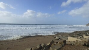 A beach with rocky terrain and a staircase leading down to the shore. - 4 The Park (Bude)