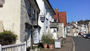 A traditional white building with a sign reading "The Old Lace Shop." - Seaweed (Sidmouth)
