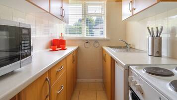 Fridge, electric kettle, toaster, cookware/dishes/utensils