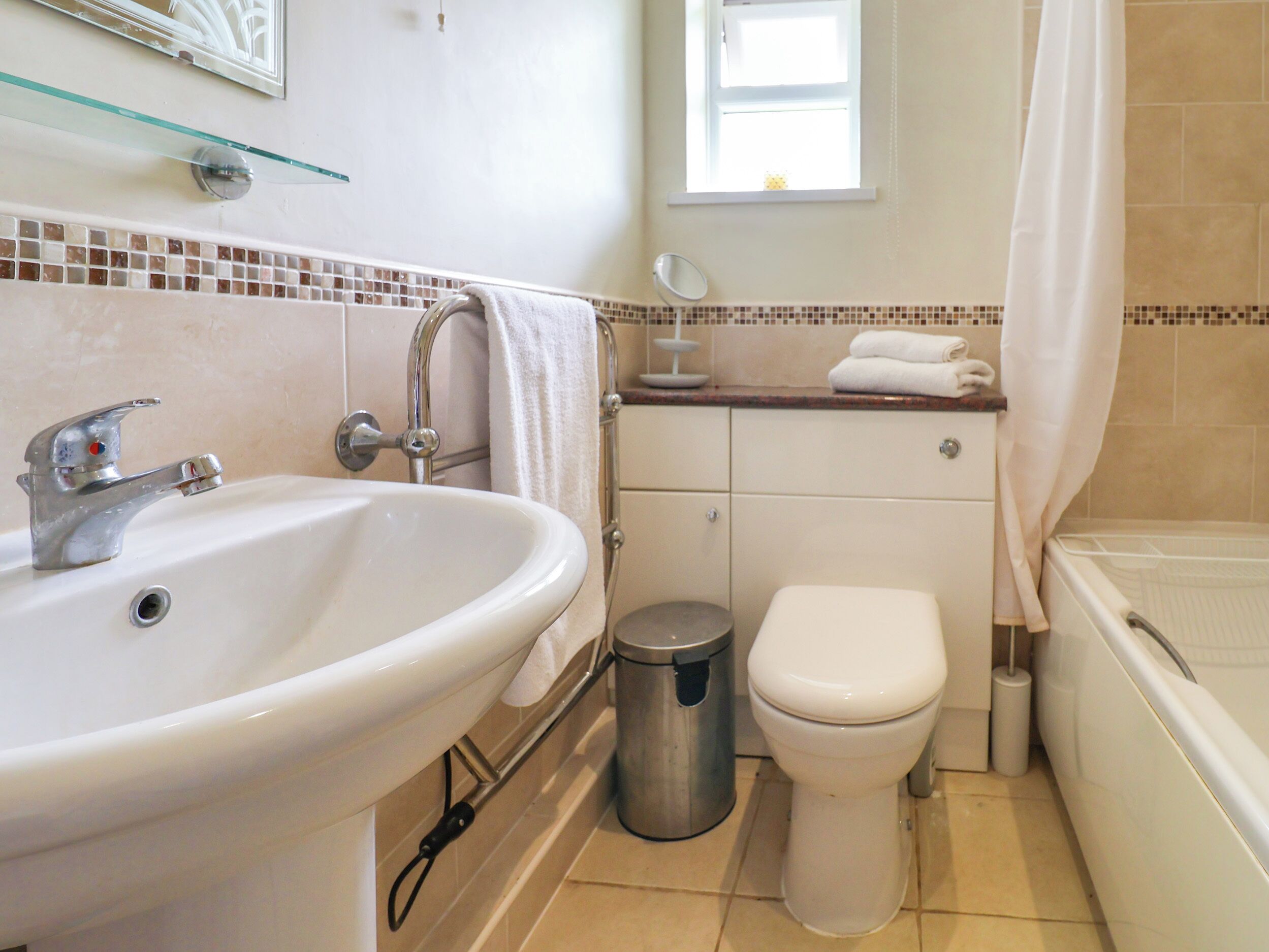 A bathroom with a sink, toilet, and bathtub.