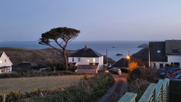 Una carretera costera que lleva a casas con vistas al mar.