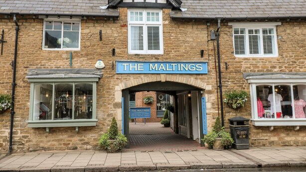 A traditional stone building with a sign reading "THE MALTINGS". - The Hideout (Oakham)