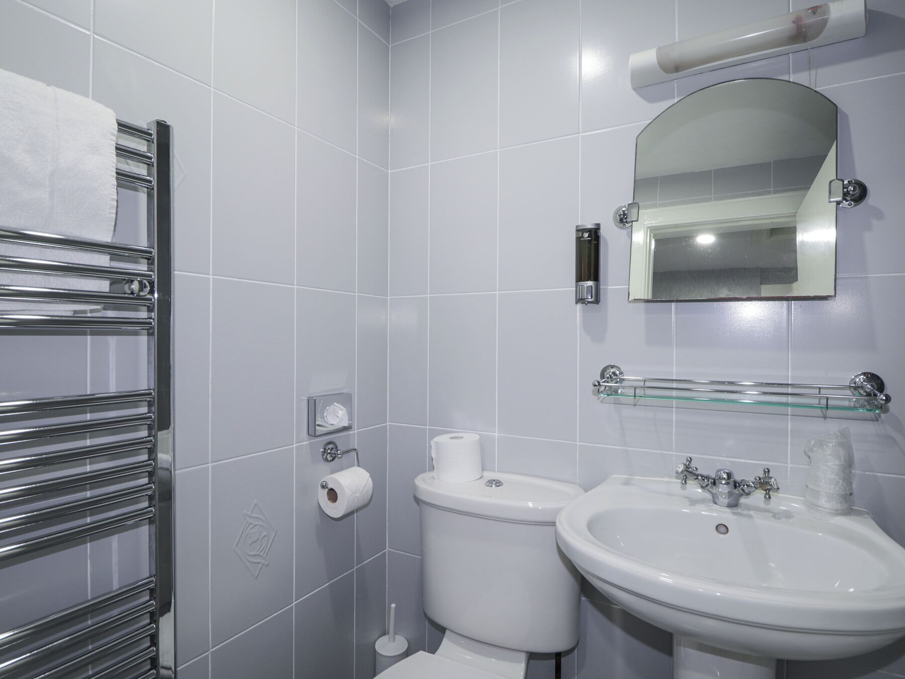 A modern bathroom with a toilet, bidet, and sink.