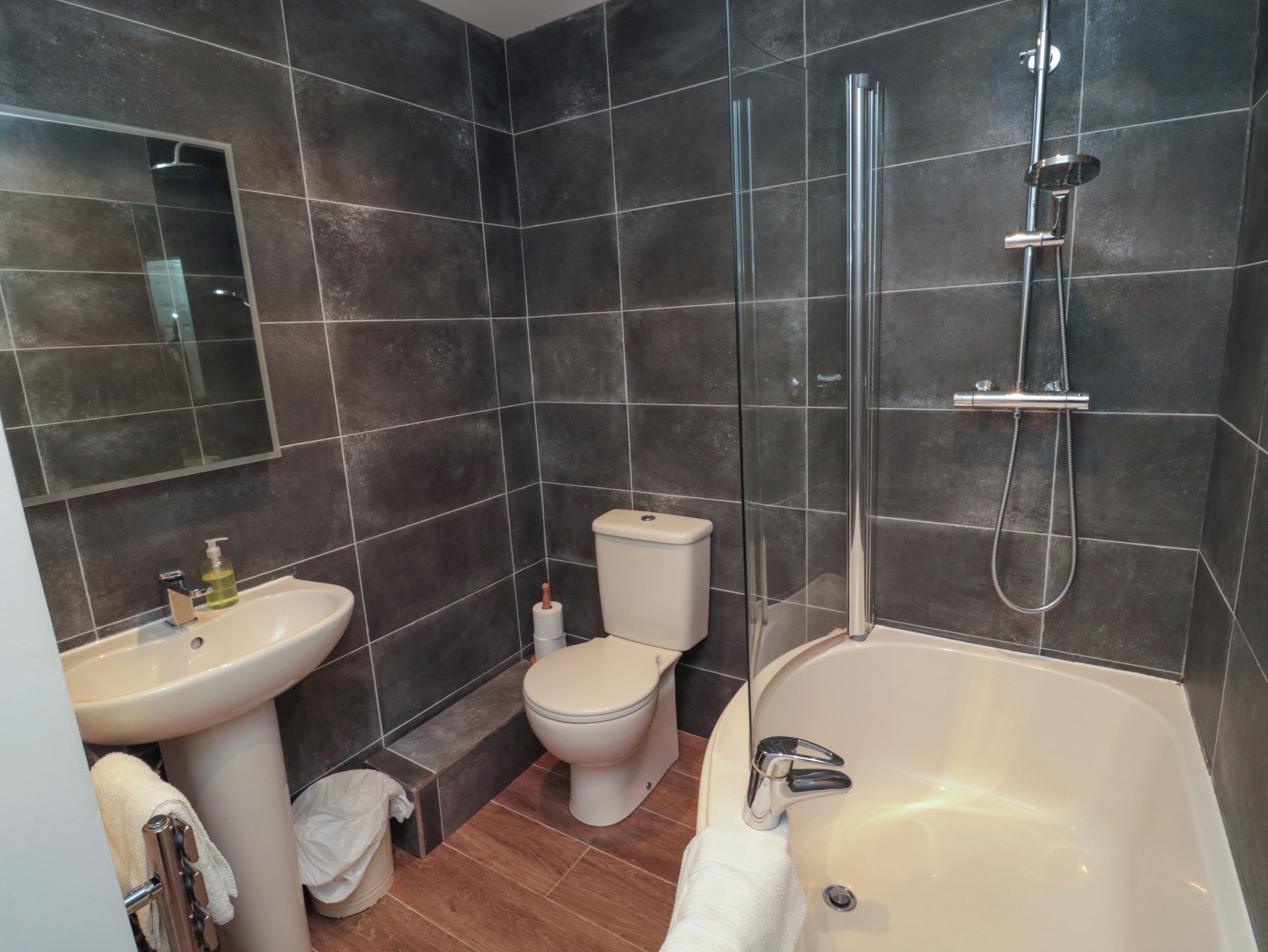A bathroom with a bathtub, a toilet, a sink, and a shower.