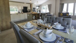 A modern kitchen with a dining area. - Bethany's Retreat (Wemyss Bay)