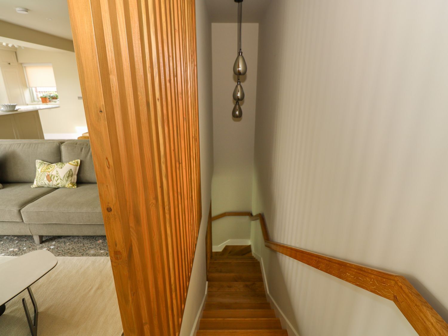 A staircase with wooden handrails leading to an upper floor.