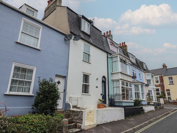 A row of terraced houses with distinct architectural styles and varying window designs. - Old Harbour Townhouse (Weymouth)