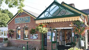 A brick building with a sign reading "Colyton Station".
