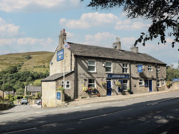 A traditional stone building with a sign reading "Lantern Pike."