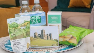 A table with a plate of crackers, tea boxes, and a booklet.